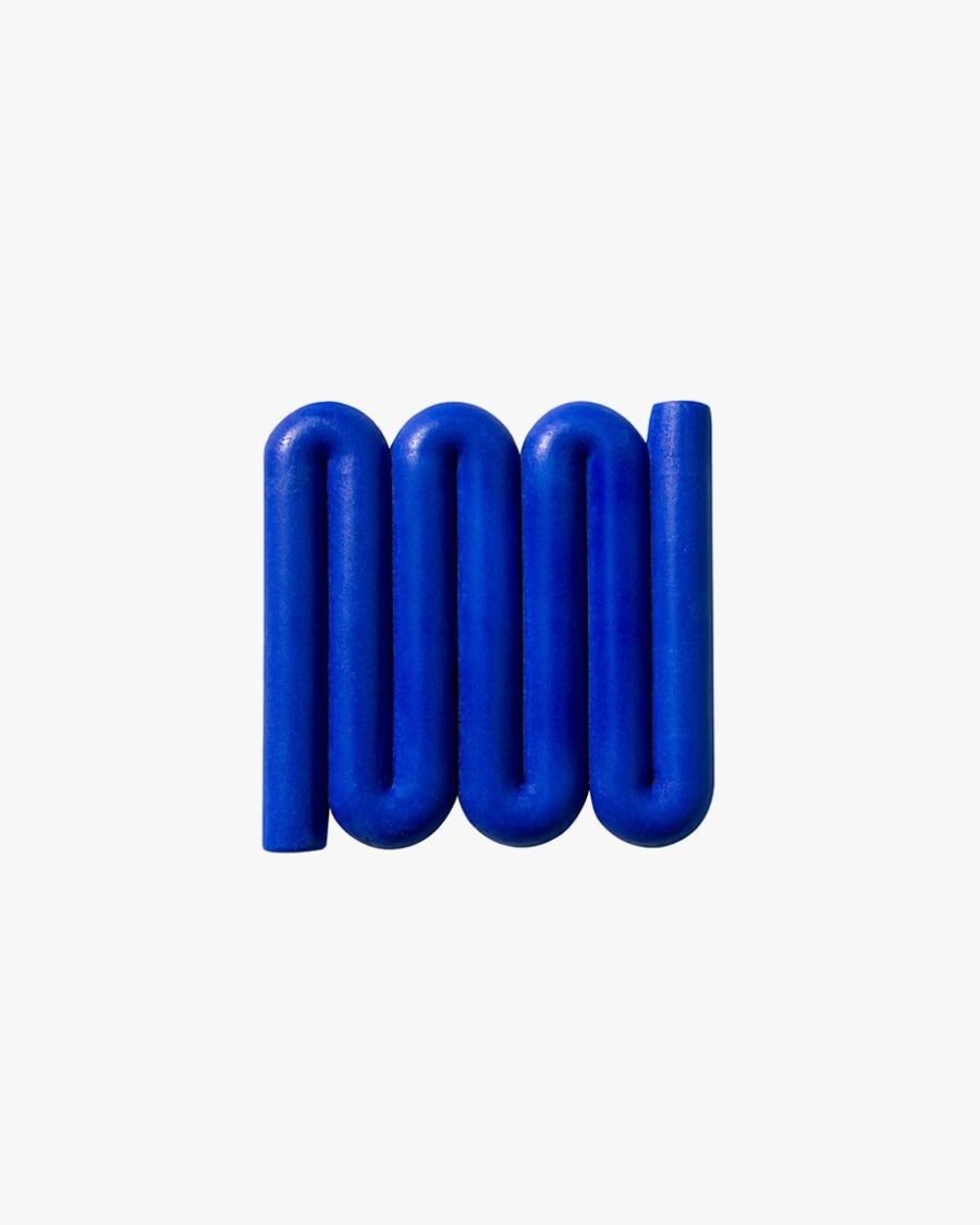 Bright blue Bandy soap dish with sinuous, curved lines designed for optimal water flow and aeration, inspired by the Australian bandy-bandy snake.