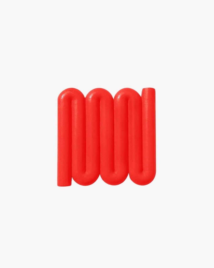 Bright red Bandy soap dish with sinuous, curved lines designed for optimal water flow and aeration, inspired by the Australian bandy-bandy snake.