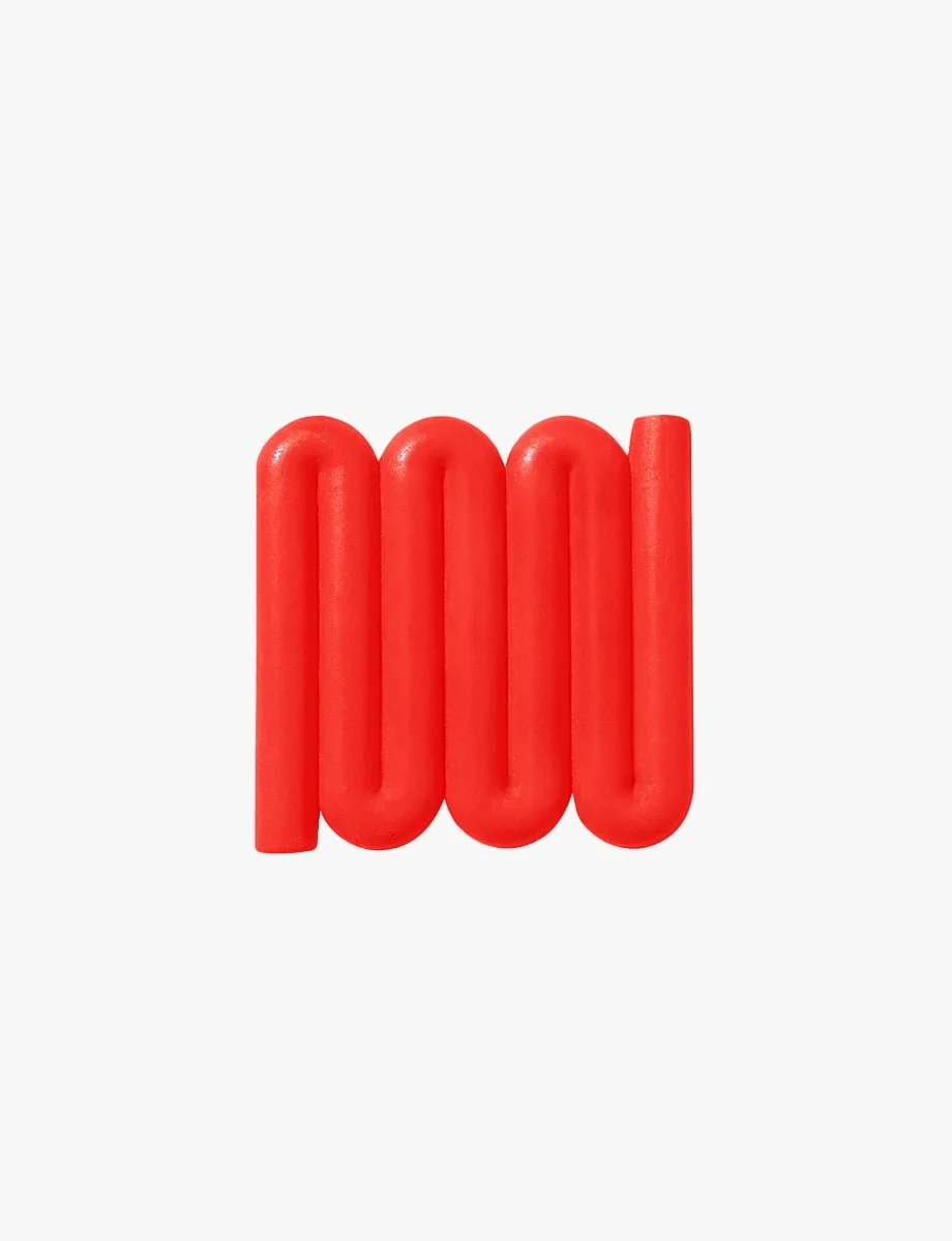 Bright red Bandy soap dish with sinuous, curved lines designed for optimal water flow and aeration, inspired by the Australian bandy-bandy snake.