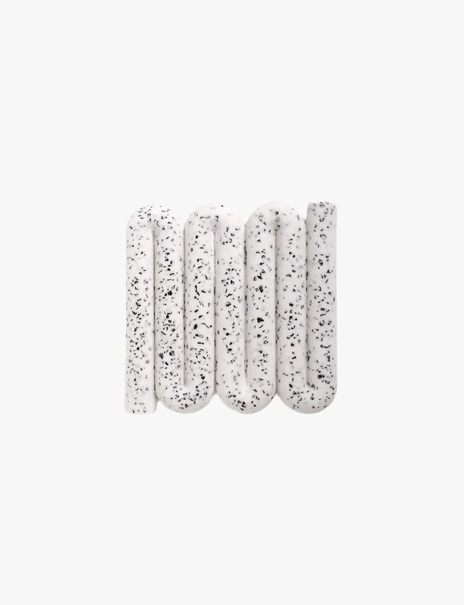 Curved, terrazzo-style Bandy soap dish and coaster in speckled white, designed for elegance and functionality in the home