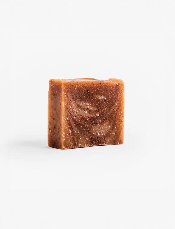 Organic banana, oats, and calendula soap with a warm, inviting appearance, perfect for dry and sensitive skin