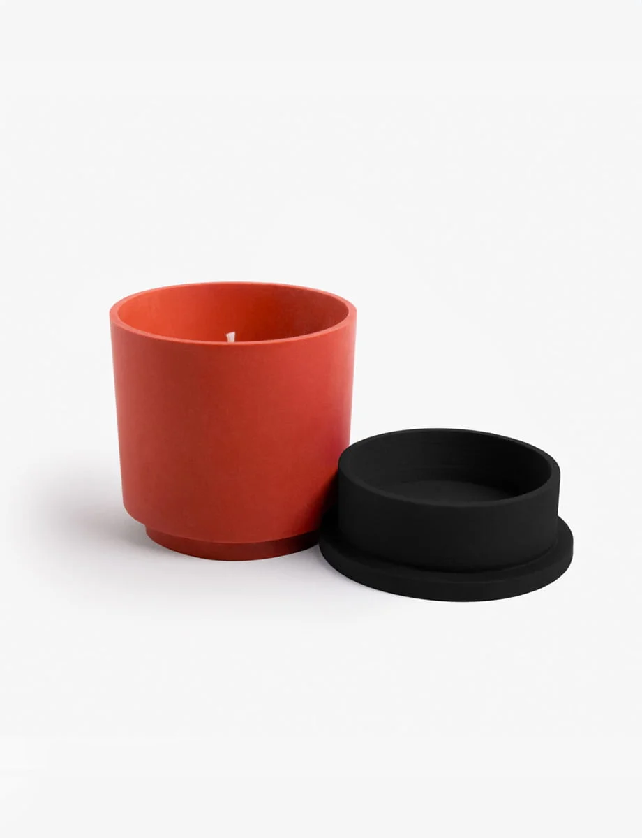 BEYOND THE PINES candle with a deep black lid and terracotta pot, exuding a balsamic pinewood scent with notes of cedar, rosemary, and eucalyptus.