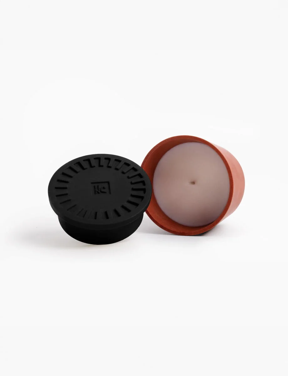 BEYOND THE PINES Scented Candle – A Forest Retreat BEYOND THE PINES candle with a deep black lid and terracotta pot, exuding a balsamic pinewood scent with notes of cedar, rosemary, and eucalyptus.