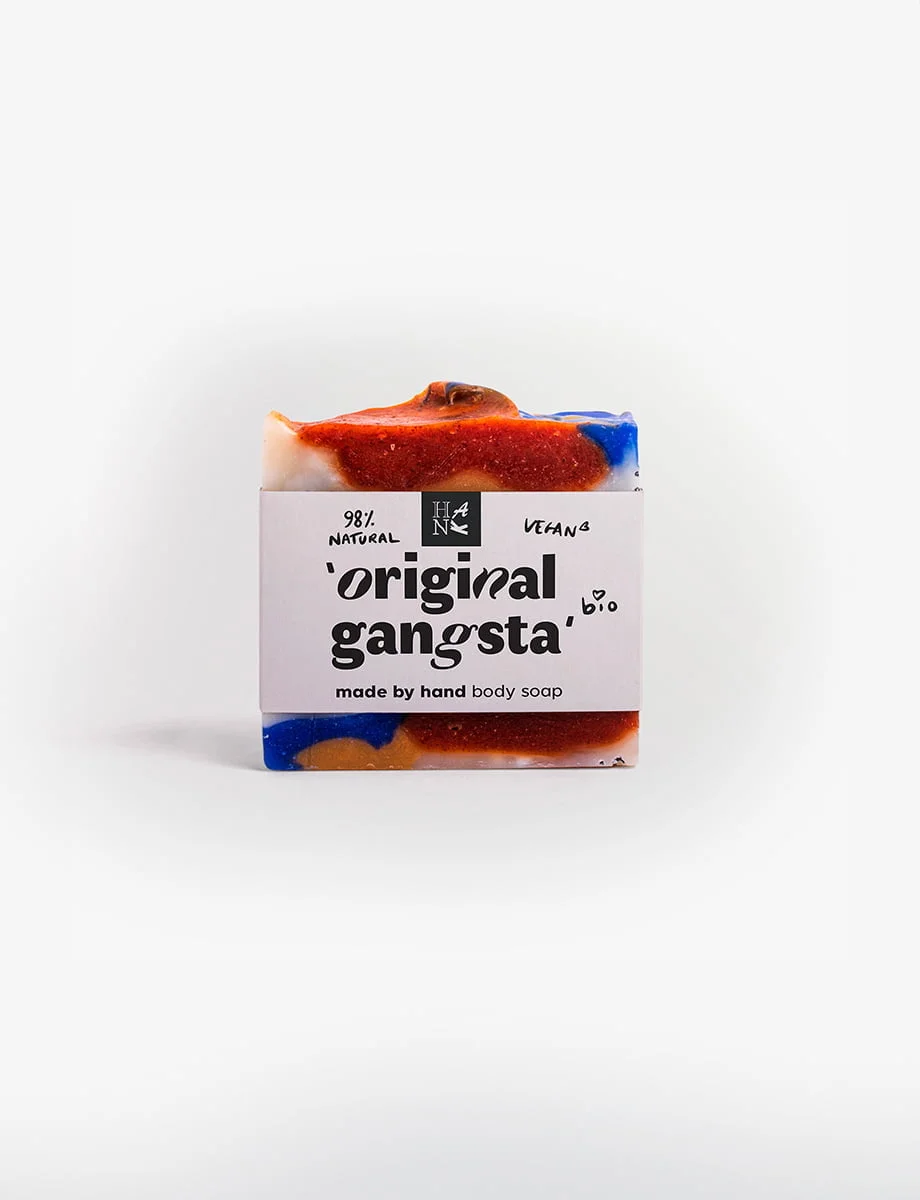 "Handmade 'ORIGINAL GANGSTA' soap with vibrant swirls of blue, orange, and red, featuring exfoliating paprika spots.