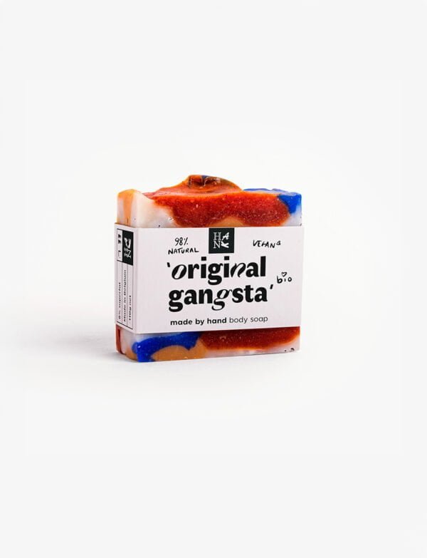 "Handmade 'ORIGINAL GANGSTA' soap with vibrant swirls of blue, orange, and red, featuring exfoliating paprika spots.