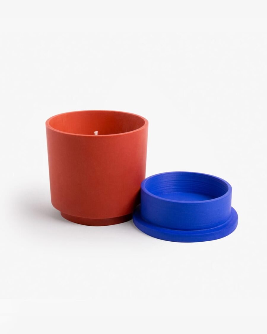 SON OF A BEACH candle in a vibrant blue Jesmonite pot with a terracotta base, exuding scents of lime, mint, salt, and rum for a beachy vibe.