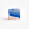 Organic soap bar inspired by the world's most pristine beaches, with blue waves and white sandy textures, scented with a fresh mojito fragrance.