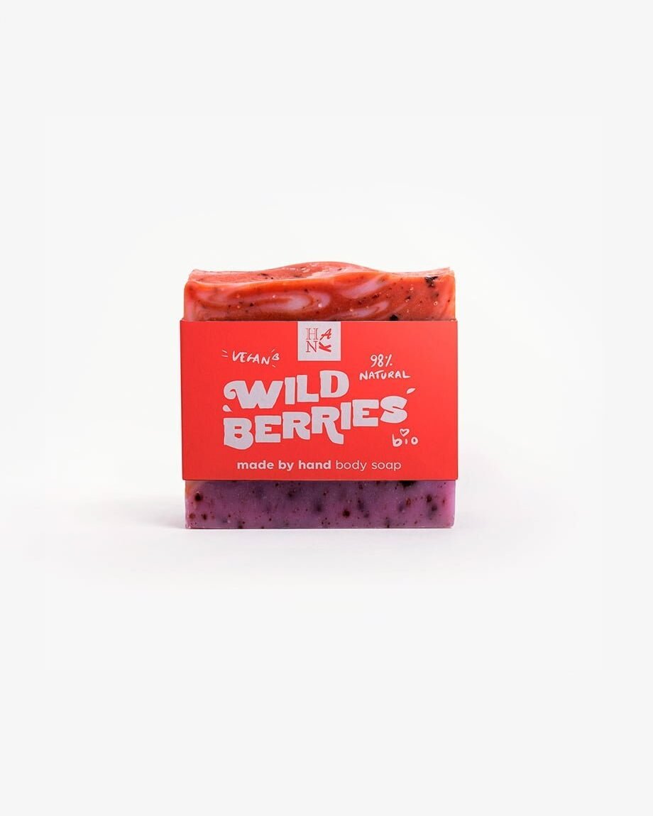 Handmade organic soap with swirls of crimson and purple, embedded with real cranberry and blueberry pieces for nourishing skincare.