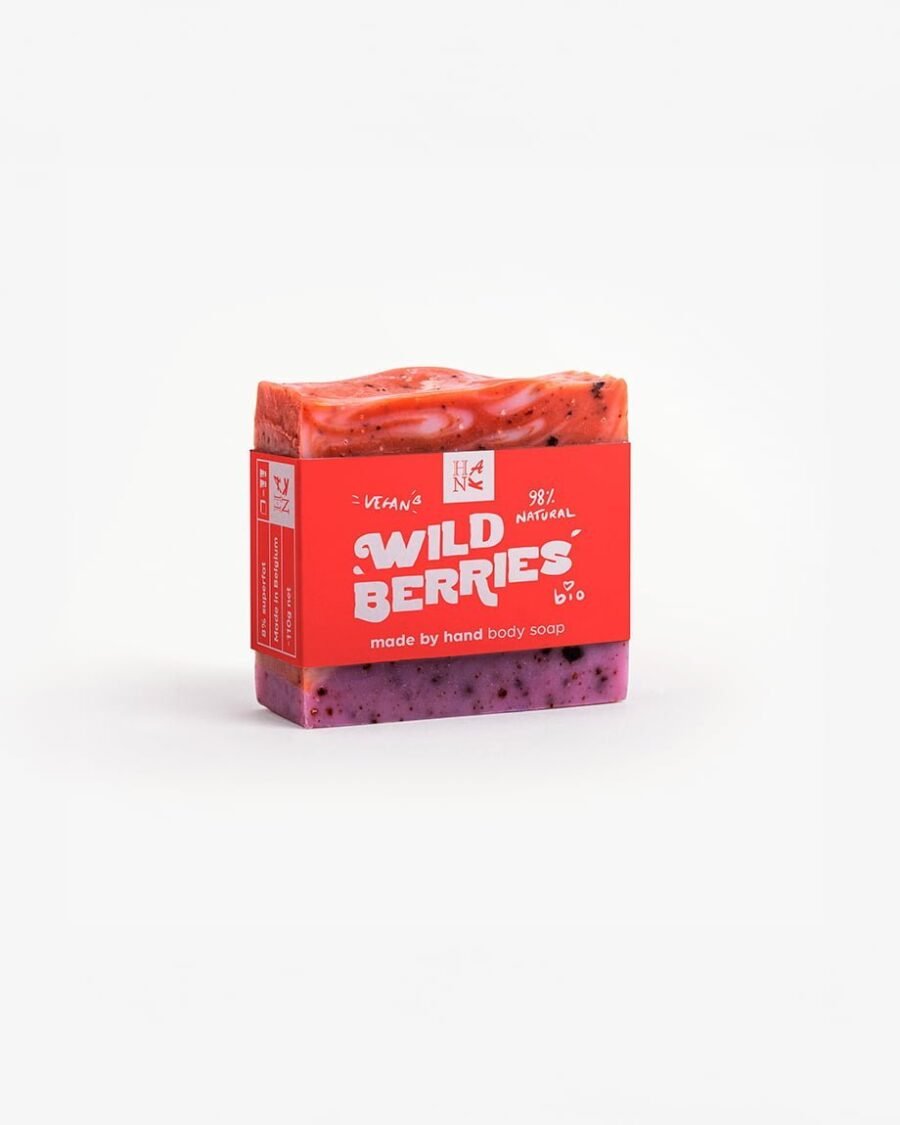 Handmade organic soap with swirls of crimson and purple, embedded with real cranberry and blueberry pieces for nourishing skincare.