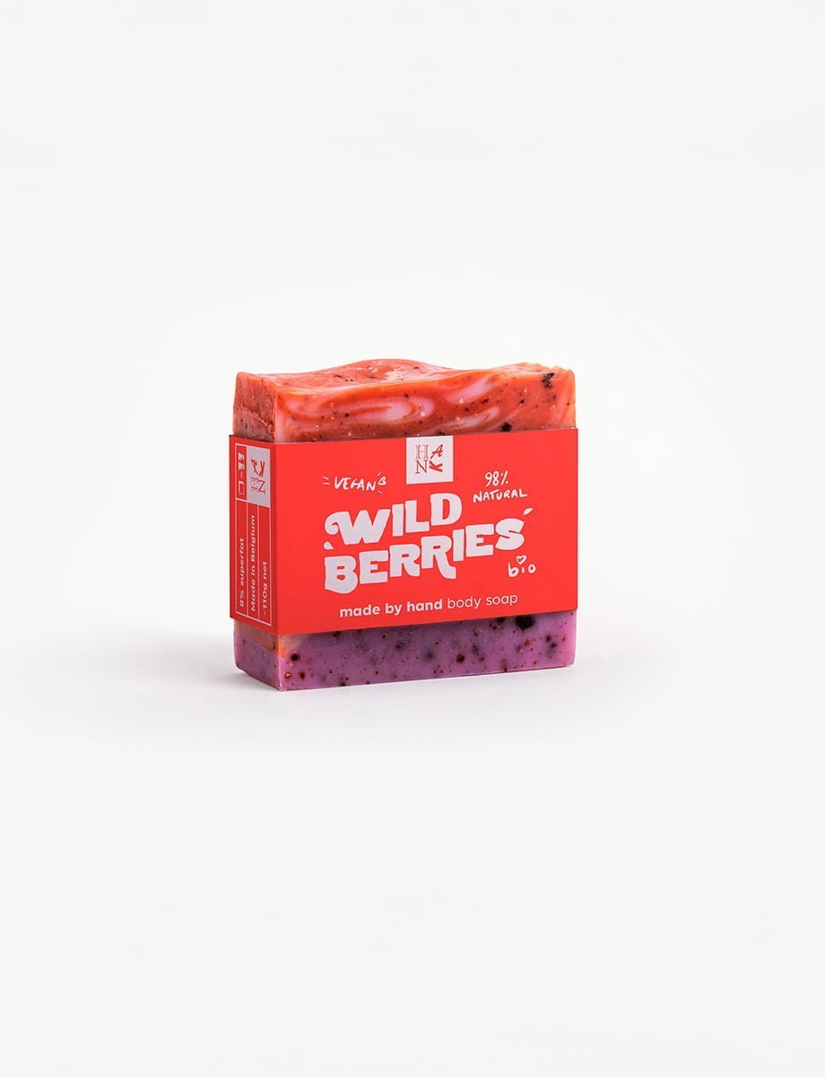 Handmade organic soap with swirls of crimson and purple, embedded with real cranberry and blueberry pieces for nourishing skincare.